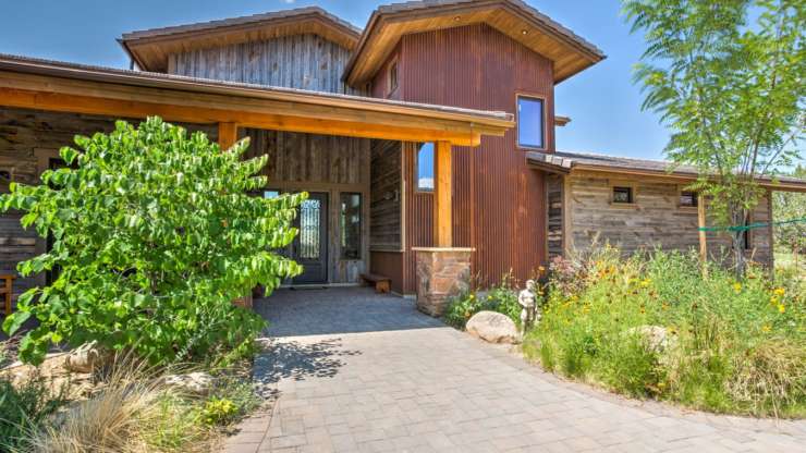 Combination of reclaimed wood siding, stone and metal used on this beautiful home